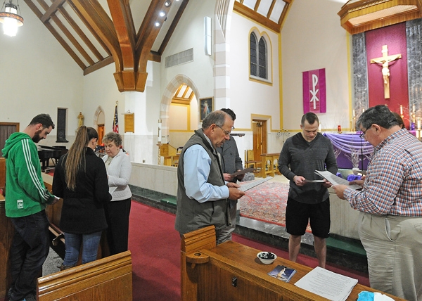 Eucharistic Ministers Nancy Ortolano and Gregory Yungbluth prepare the faithful to receive ashes Wednesday evening during the 15 hours of ashes at St. Benedict Church on Main Street in Amherst. (Dan Cappellazzo/Staff Photographer)